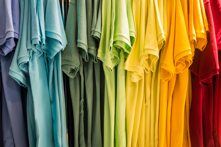 t-shirts arranged by the colors of the rainbow