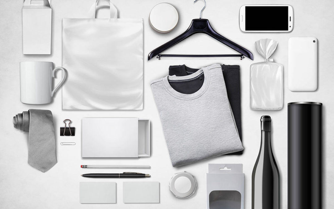 Assorted everyday items including a branded apparel franchise t-shirt, smartphone, notebook, thermal bottle, and promotional product franchise accessories laid out on white.
